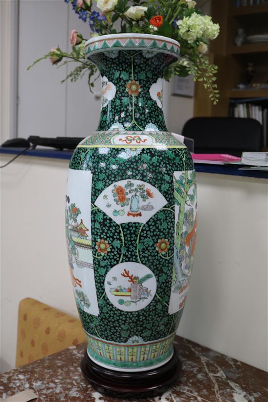 A pair of large Chinese porcelain vases with hardwood stands